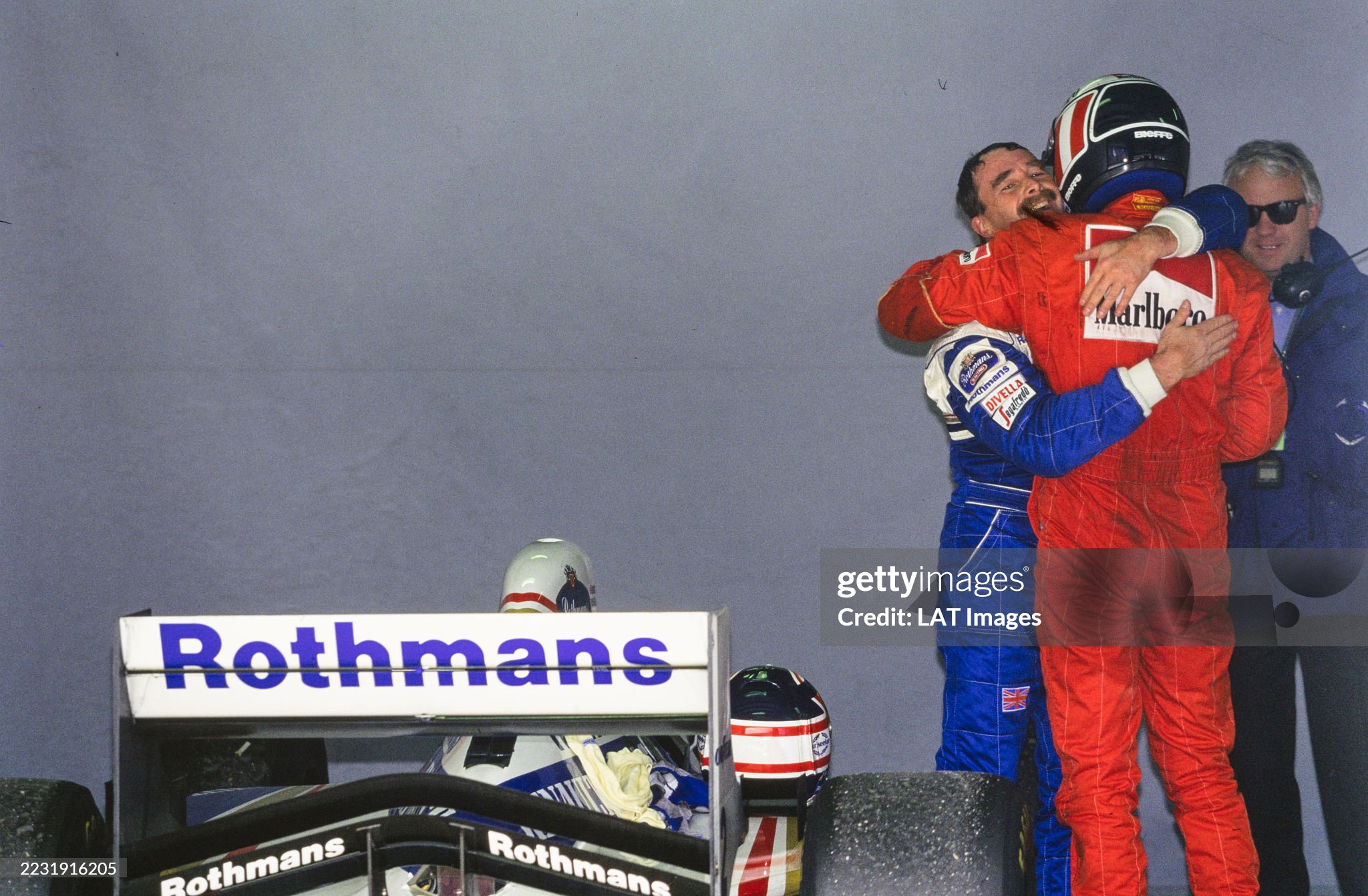 Gerhard Berger congratulates Nigel Mansell in Parc Ferme. Charlie Whiting can be seen standing beside the pair after the Australian Grand Prix at Adelaide street circuit on 13 November 1994. 