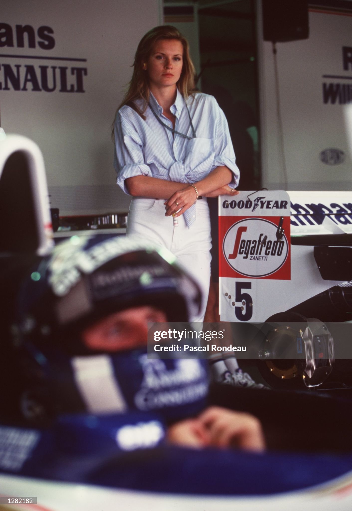 David Coulthard before the start of the Brazilian Grand Prix while his girlfriend watches him in the background. 