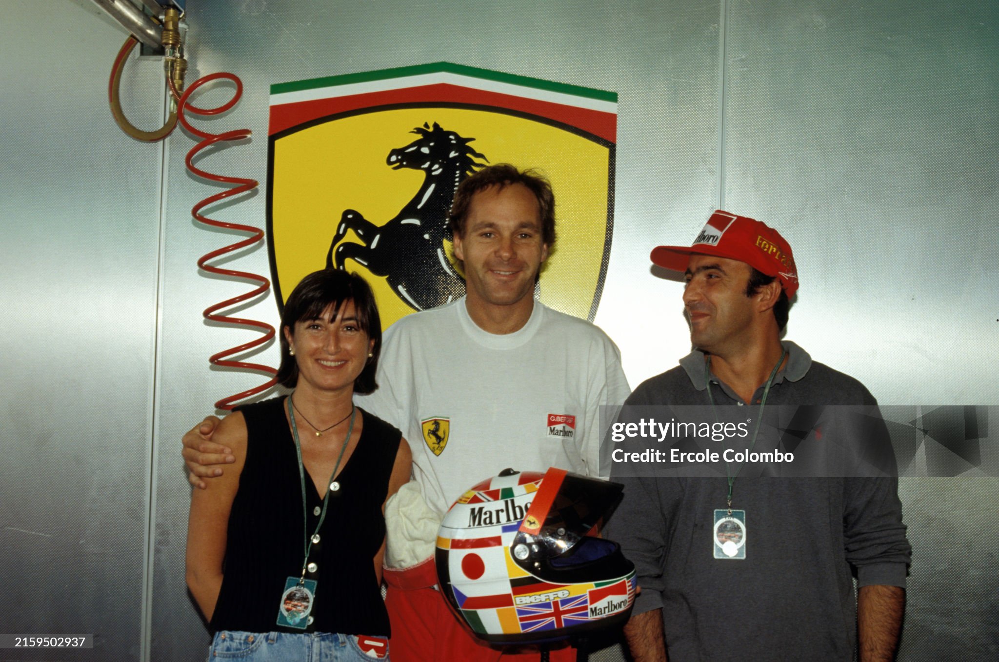 Gerhard Berger with the winners who designed a new helmet design as the result of a competition run in an Italian newspaper during the Portuguese Grand Prix at Estoril. 