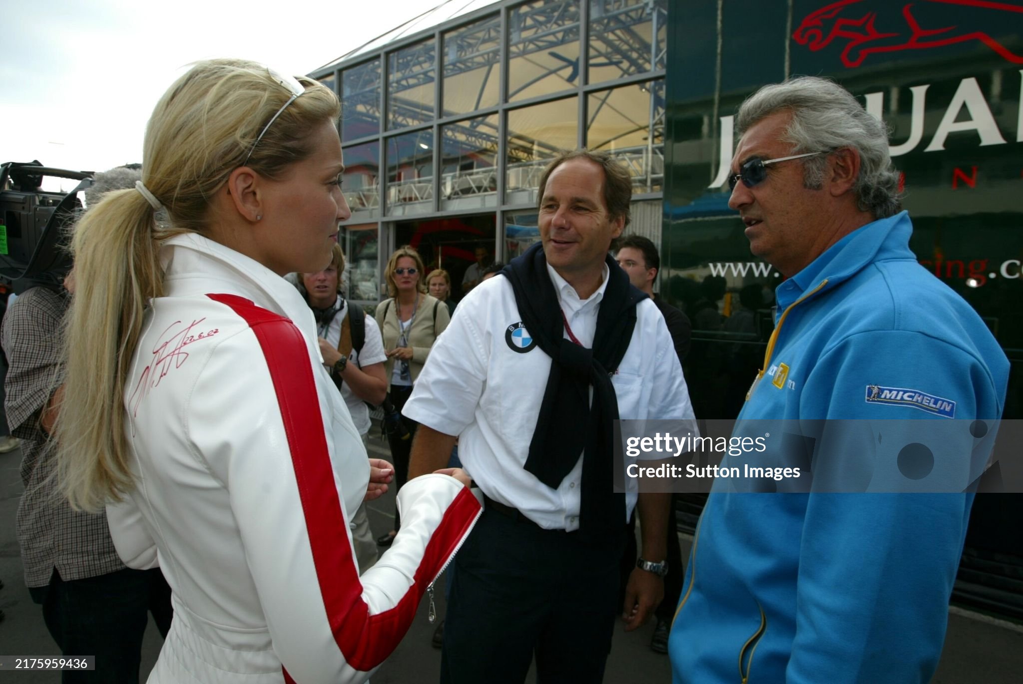 Gerhard Berger. BMW motorsport competitions director and Flavio Briatore, Renault F1 team manager, take an interest in the autographed girl at the European Grand Prix in Nurburgring, Germany, on 23 June 2002. 