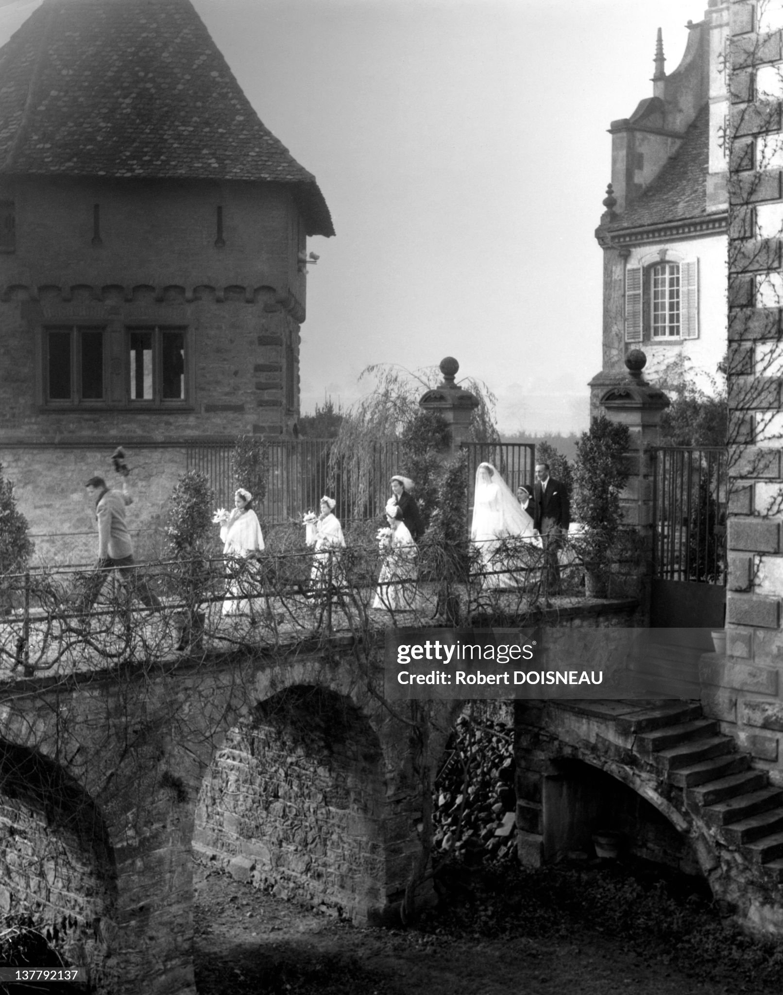 Donna Marella Caracciolo di Castagneto, her father Filippo Caracciolo and attendants leaving the Chateau Gruvel for Donna Marella's wedding ceremony with Giovanni Agnelli on 19 November 1953 in Osthoffen, France. 
