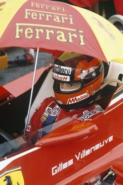 French Grand Prix at Paul Ricard on 02 July 1978. Gilles Villeneuve stays protected under an umbrella in the pitlane. 