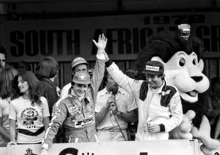 Race winner Gilles Villeneuve, Ferrari, celebrates on the podium with third placed Jean-Pierre Jarier, Tyrrell, at the South African Grand Prix on 03 March 1979. 