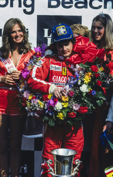 Winner Gilles Villeneuve on the podium at Long Beach, USA, on 08 April 1979. 