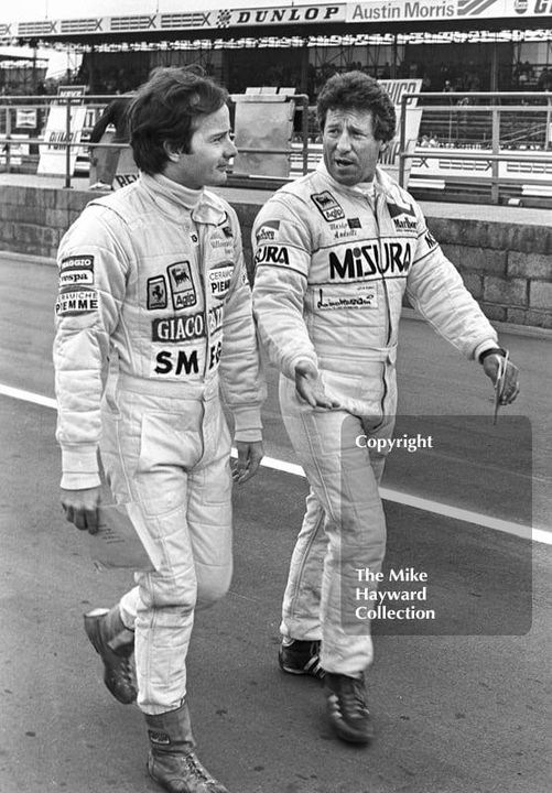 Gilles Villeneuve and Mario Andretti walking down the Silverstone pit lane during qualifying for the 1981 British Grand Prix.