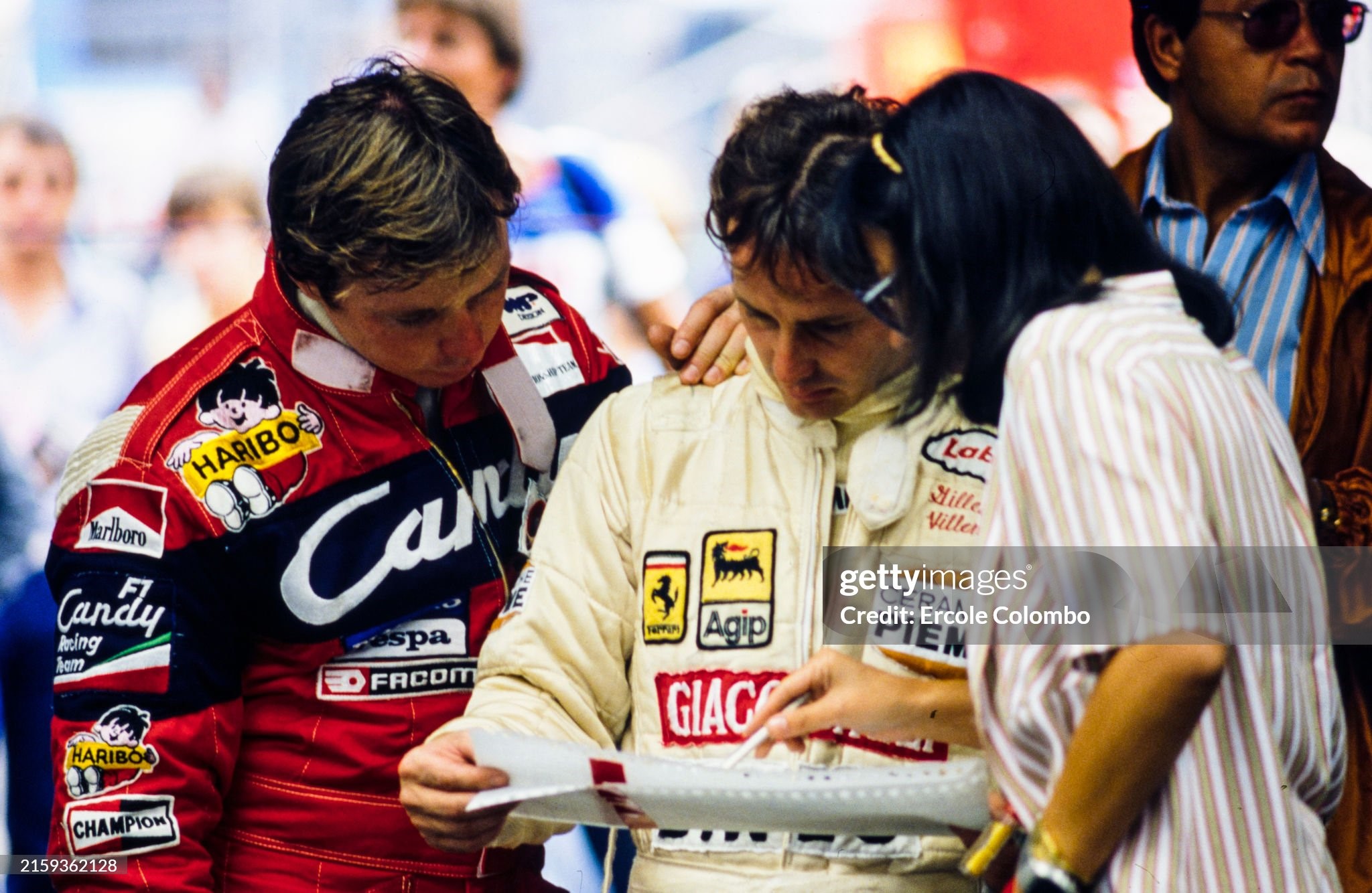 Didier Pironi and Gilles Villeneuve examine laptimes with Gilles' wife Joann during the German Grand Prix at Hockenheimring on 02 August 1981. 