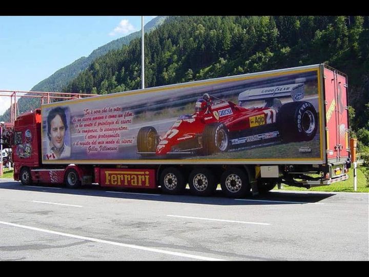 A truck with a photo of Gilles Villeneuve and his Ferrari.