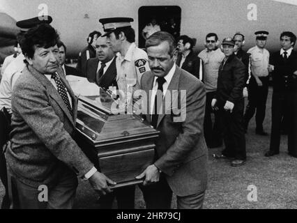 The body of Gilles Villeneuve is carried to a waiting hearse after arriving in Montreal on 10 May 1982 aboard a Canadian Forces plane. 