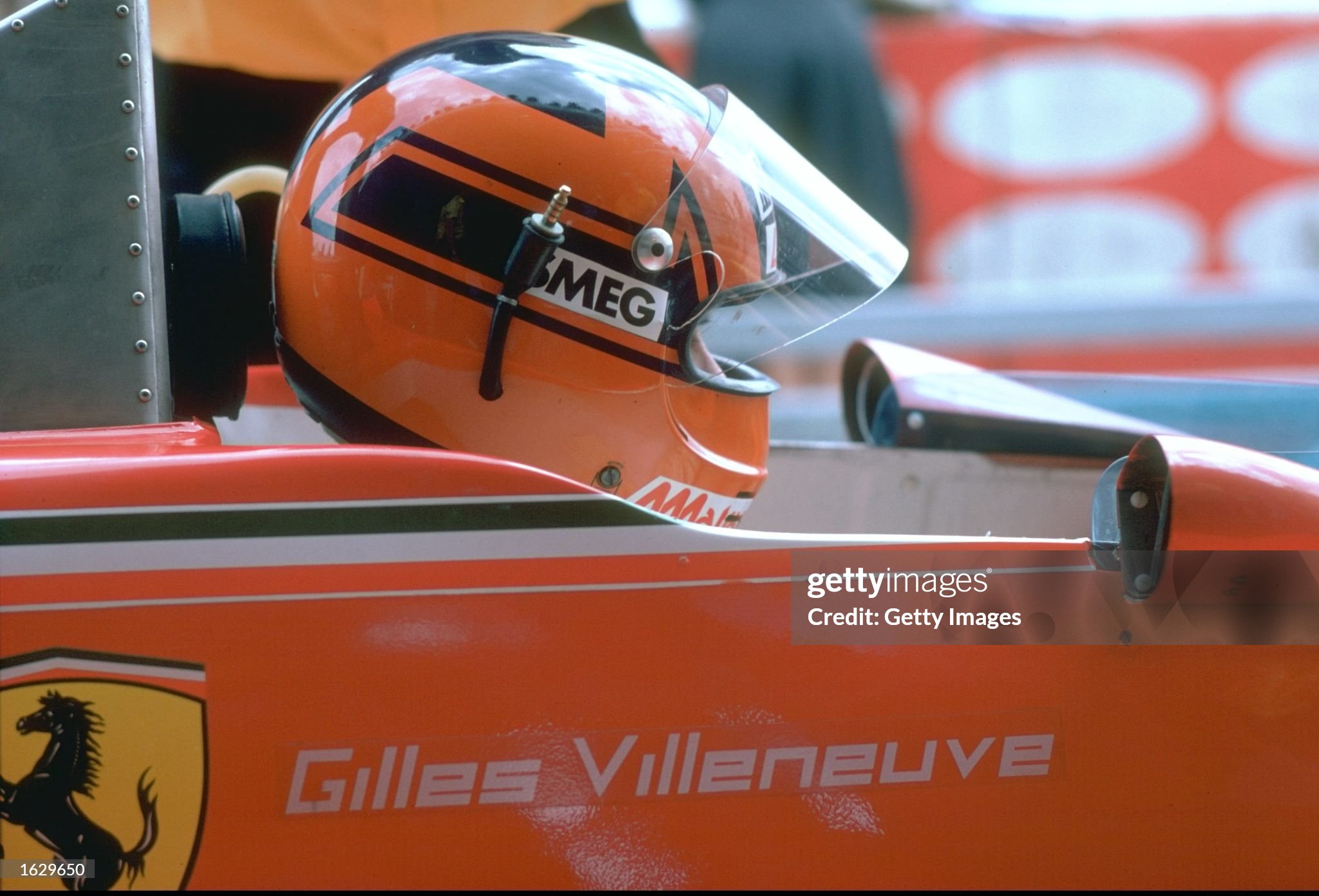 August 1979: portrait of Gilles Villeneuve in his Ferrari before a Formula One race. 