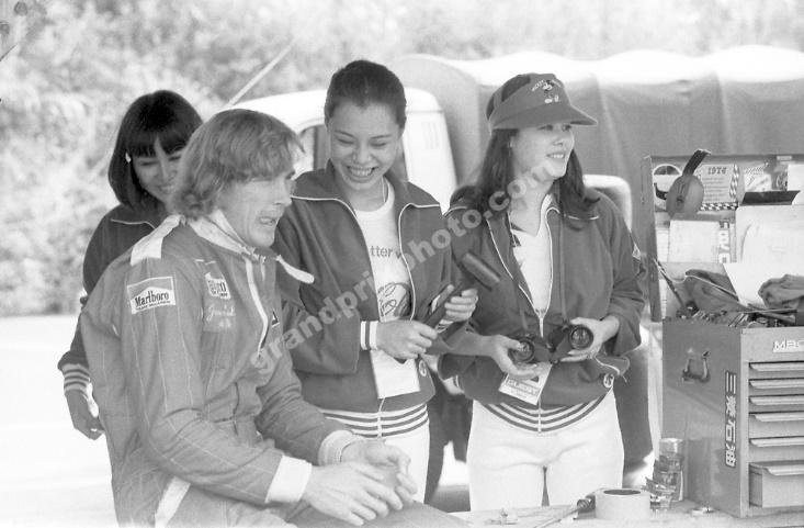 1976 Japanese Grand Prix. Fuji, Japan. 22nd - 24th October 1976. James Hunt (McLaren M23-Ford), 3rd position, in the paddock with girls, portrait.