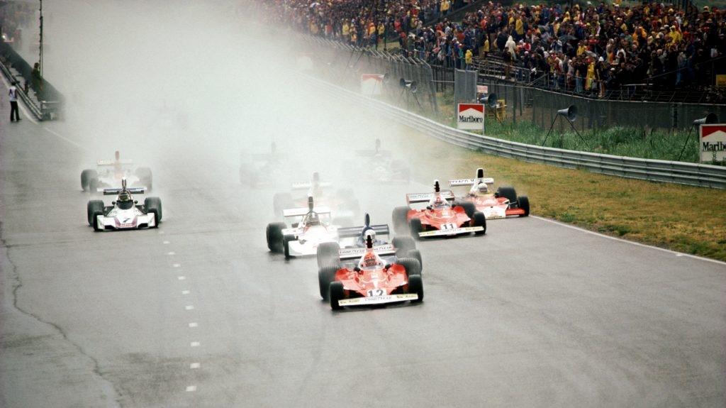 Lauda leads the field through the spray.