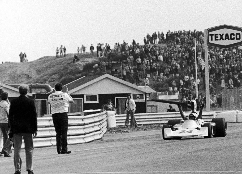The famous victory at Zandvoort in 1975. A jubilant Lord Hesketh waits for James as he comes around to the pits after successfully winning the 1975 Dutch Grand Prix by one second. 