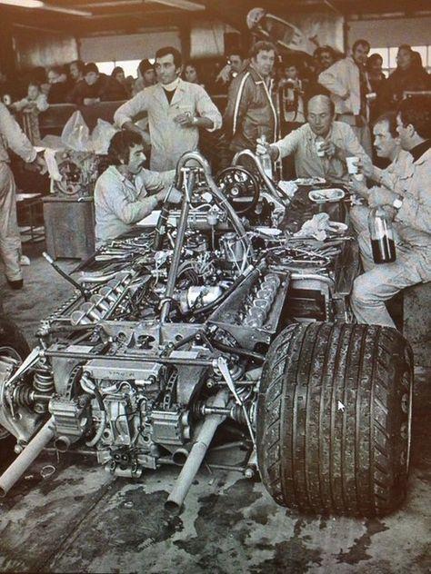 Italian mechanics working on a Ferrari 312 under pressure, with an antipasto platter, bottle of red wine and jovial conversation.