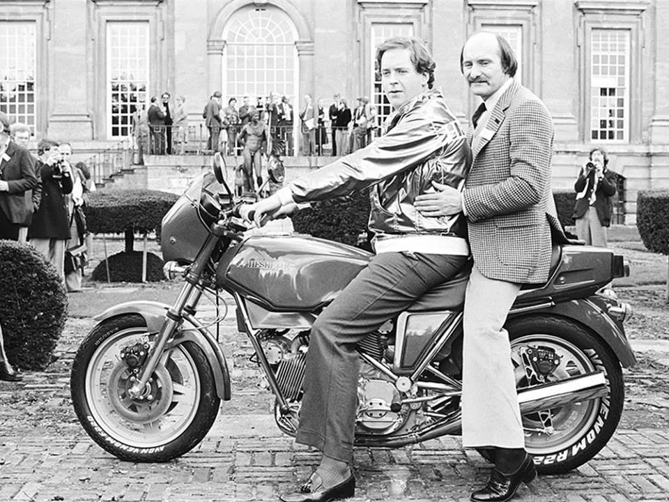 Lord Hesketh riding a bike with a friend.