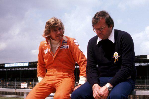 James Hunt with Anthony 'Bubbles' Horsley, Hesketh Team Manager, at their local British Grand Prix, Silverstone, 19 July 1975.