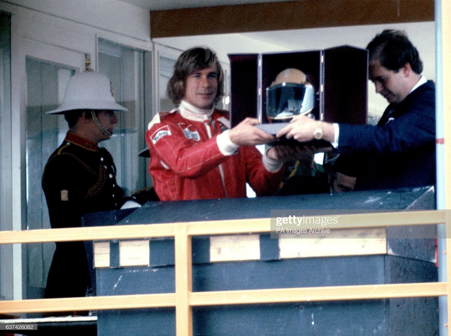 Formula One World Champion James Hunt is presented with a golden helmet by Lord Hesketh in 1976.