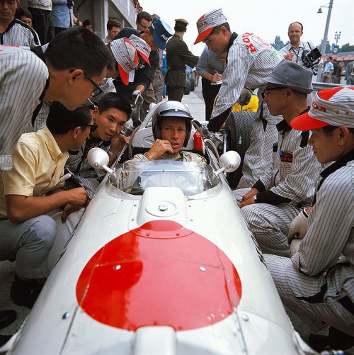 The Honda F1 team at Monza in 1966. The driver should be Richie Ginther. Note the beautiful car design and the cutest stripy pit crew uniforms ever seen.