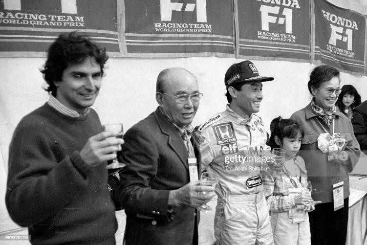 Soichiro Honda (2nd left) congratulates World Champion Nelson Piquet (1st left) and Satoru Nakajima (3rd left) after the Formula One Japanese Grand Prix at Suzuka Circuit on November 1, 1987. 