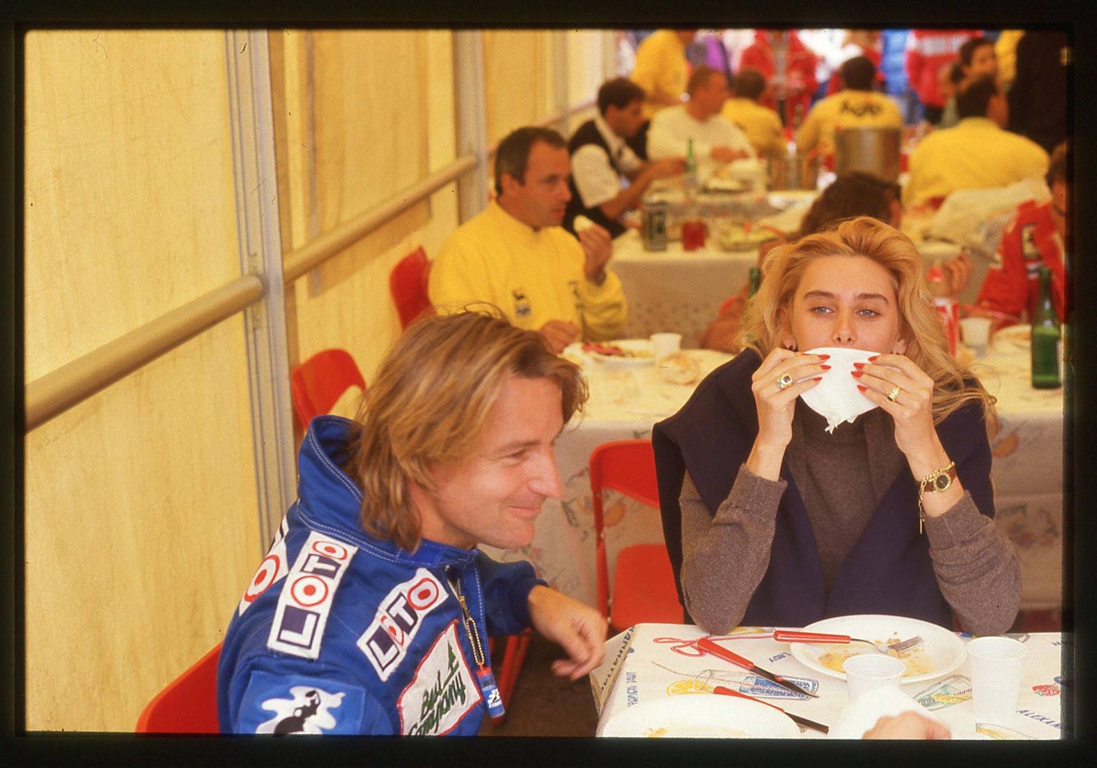 René Arnoux with a blonde female fan in the Ferrari motorhome at Imola in 1988.