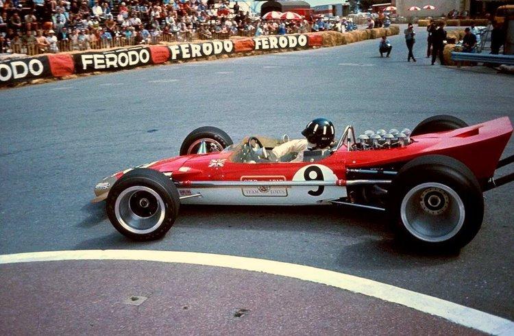 Graham Hill driving a red Lotus in Monte Carlo.