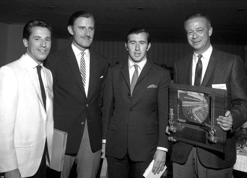 The 1967 Indianapolis Banquet. Mario Andretti is channeling the Godfather and jolly nice he looks too. Jackie Stewart is keeping it simple and Graham Hill is keeping it English in a dubious blazer and slacks.
