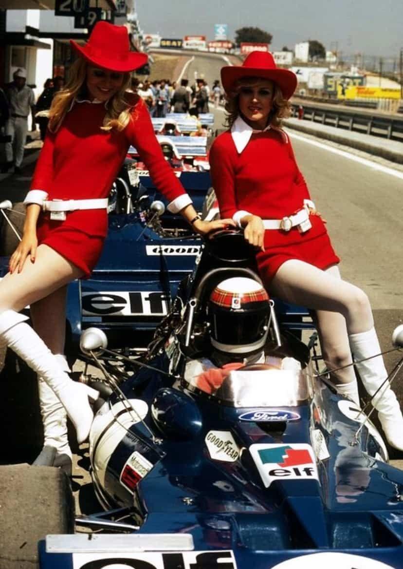 Jackie Stewart in a Tyrrell with two girls. 