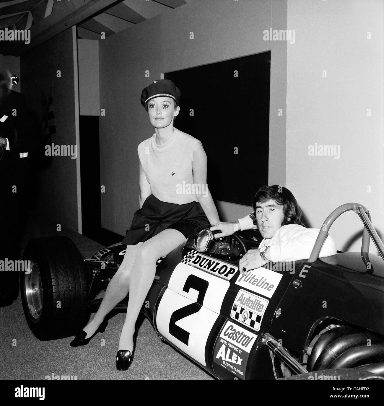 Jackie Stewart is joined by a model to advertise Dunlop tyres in London in 1969.