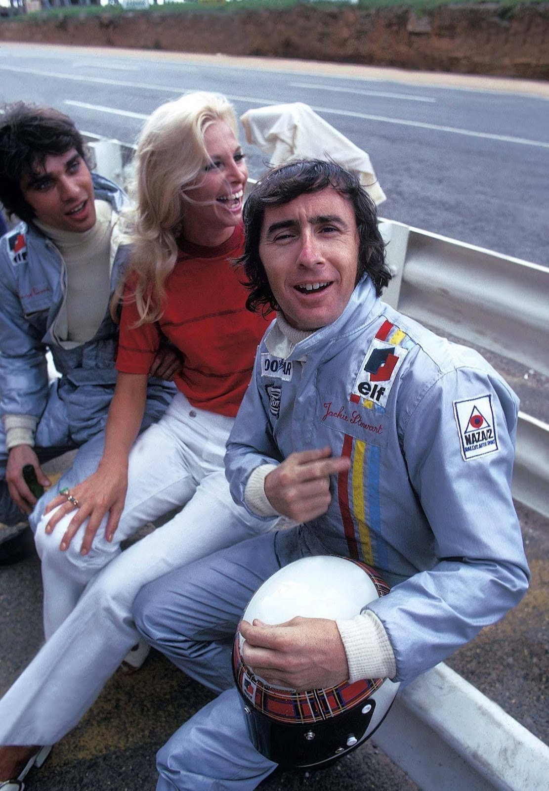 Jackie Stewart with Francois Cevert and a girl.