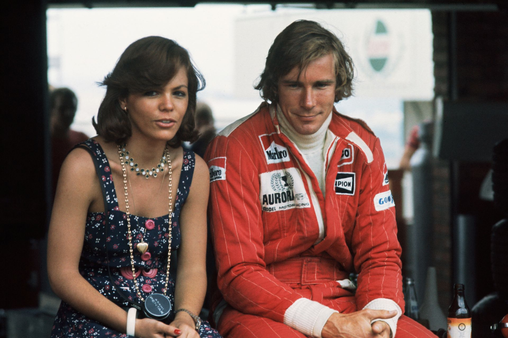 South African Grand Prix at Kyalami, South Africa, on 4th - 6th March 1976. James Hunt with a female fan in the pit lane. 