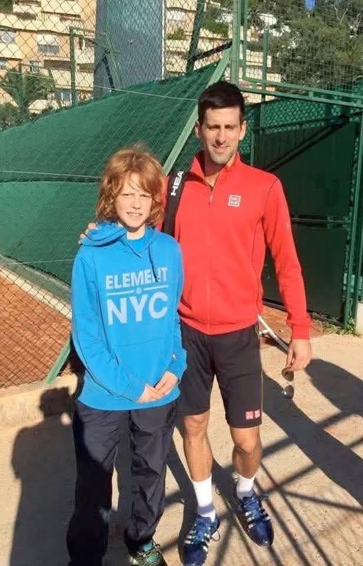 A young Jannik Sinner with Novak Djokovic.