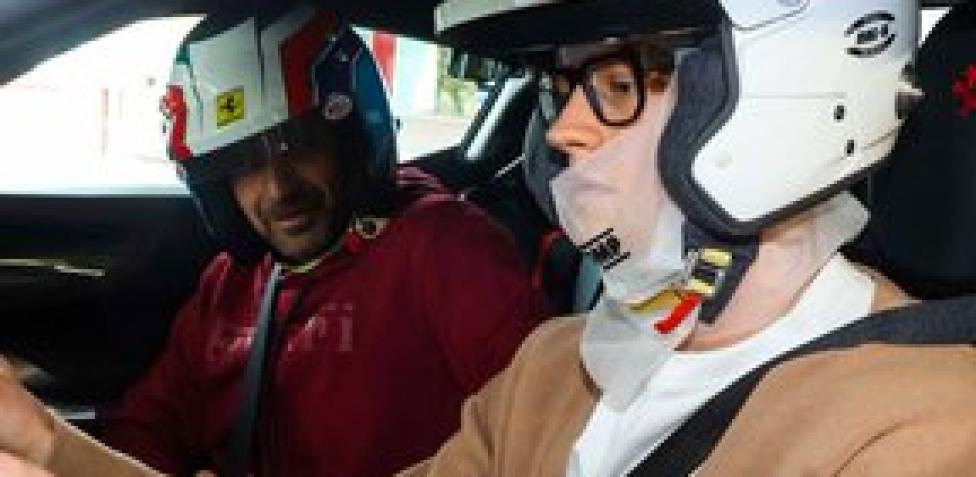Jannik Sinner taking the wheel of a Ferrari SF90 with an instructor on Enzo Ferrari’s private Maranello test track.