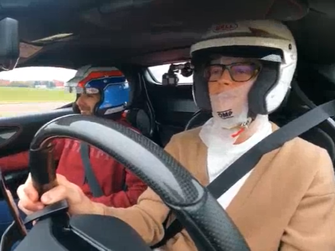 Jannik Sinner taking the wheel of a Ferrari SF90 with an instructor on Enzo Ferrari’s private Maranello test track.