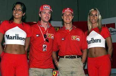 Eddie Irvine, Michael Schumacher and two girls.