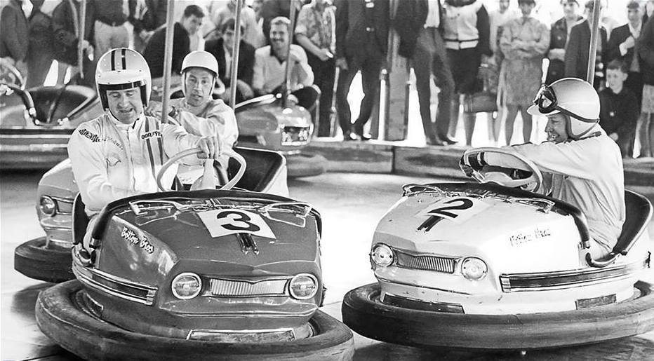Denny Hulme, Stirling Moss and John Surtees on the dodgem cars at Battersea Fun Fair on July 30th 1968, filming for a Granada TV show called 'Nice Time'.