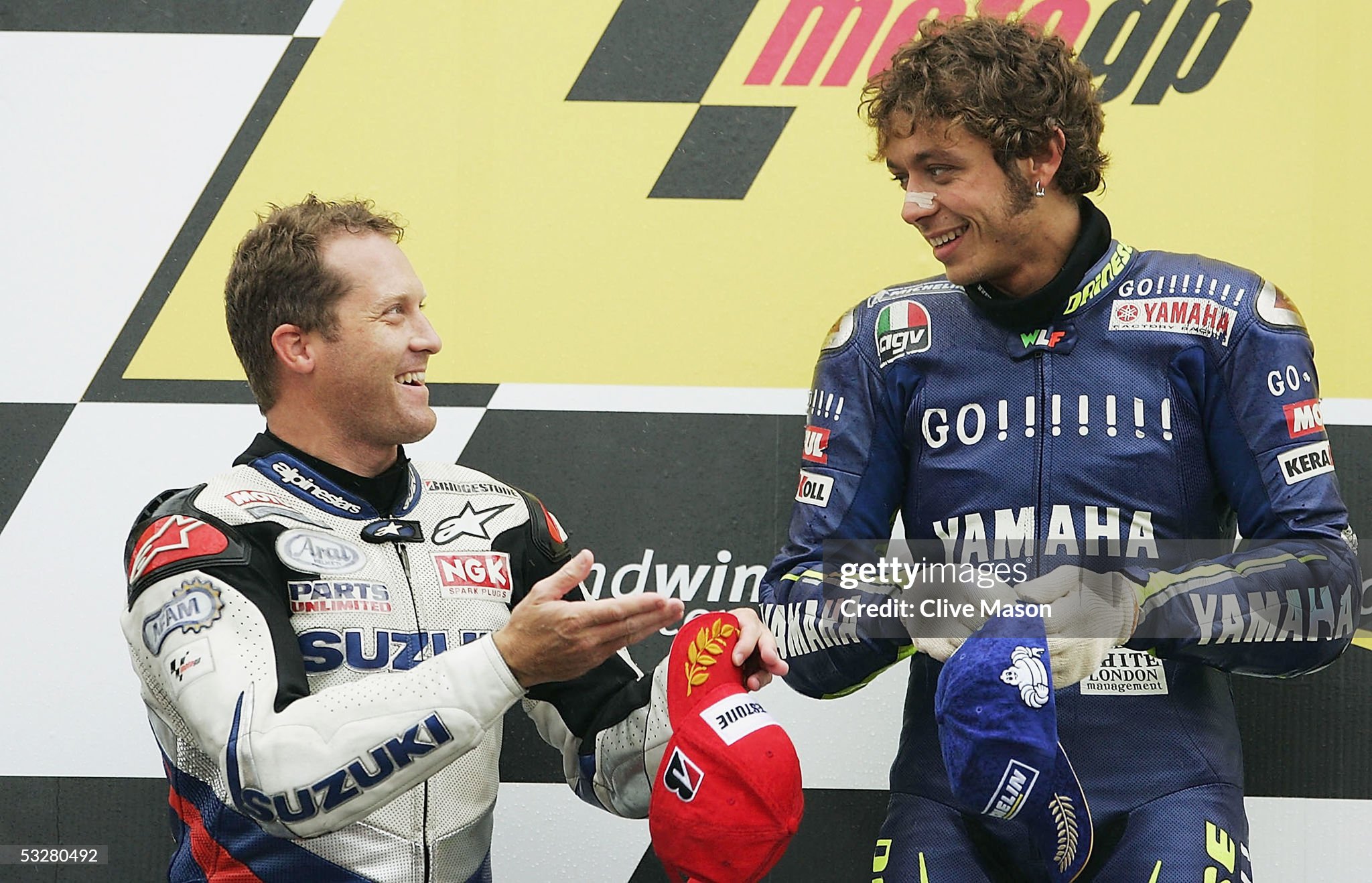 Valentino Rossi, Yamaha, jokes with Kenny Roberts, Suzuki, after victory in the British Moto GP at Donington Park on July 24, 2005. 