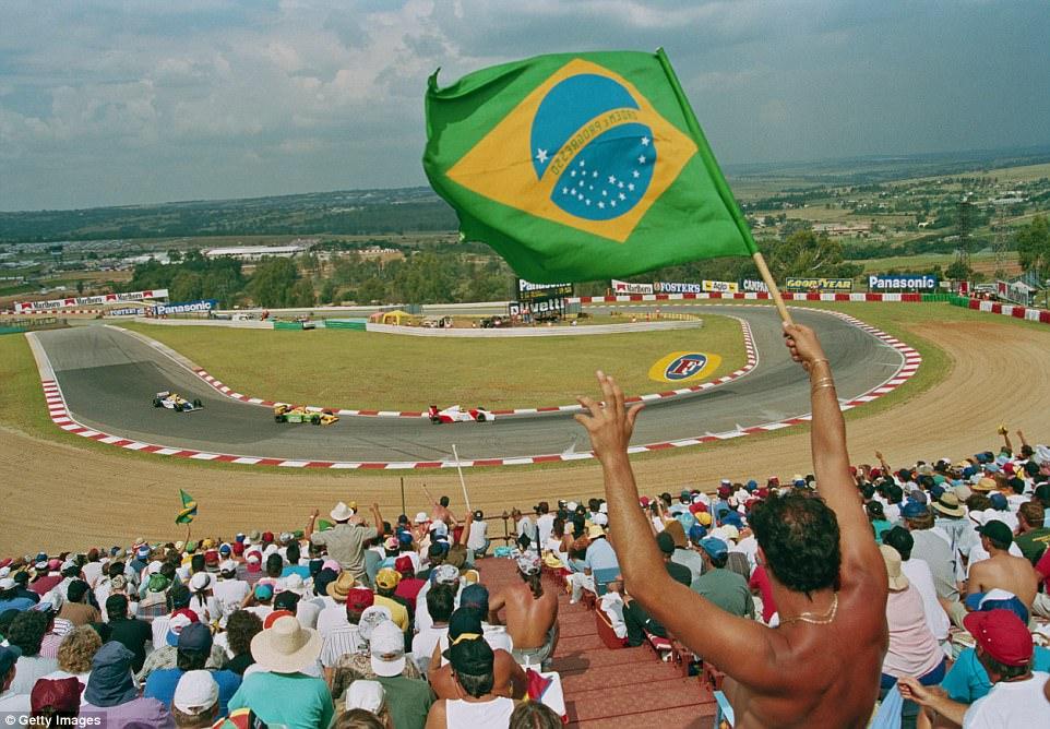 Judging by these F1 fans you could be mistaken for thinking this was a race in Brazil. But the flags are in South Africa and they are for Senna, who leads Schumacher and Prost around Kyalami in the 1993 season.