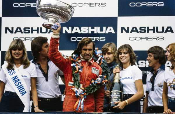 Carlos Reutemann, 1st position, celebrates on the podium at Kyalami in 1981. 