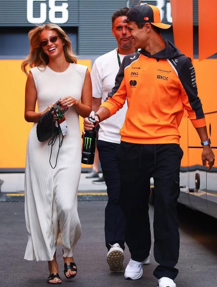 Lando Norris walks in the paddock with Magui Corceiro during final practice ahead of the 2025 Hungarian Grand Prix.