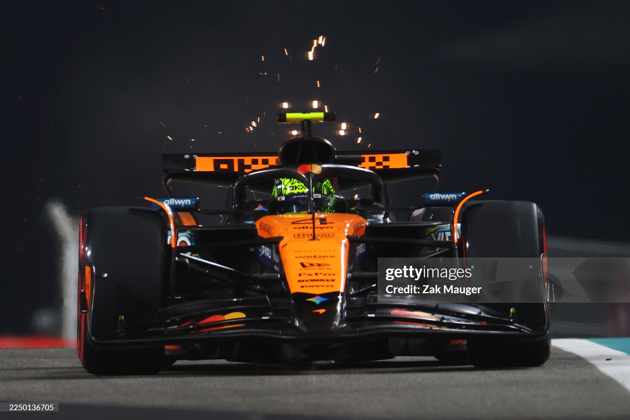 Sparks fly behind Lando Norris driving the McLaren MCL39 Mercedes on track during practice ahead of the F1 Grand Prix of Abu Dhabi at Yas Marina circuit on 05 December 2025. 