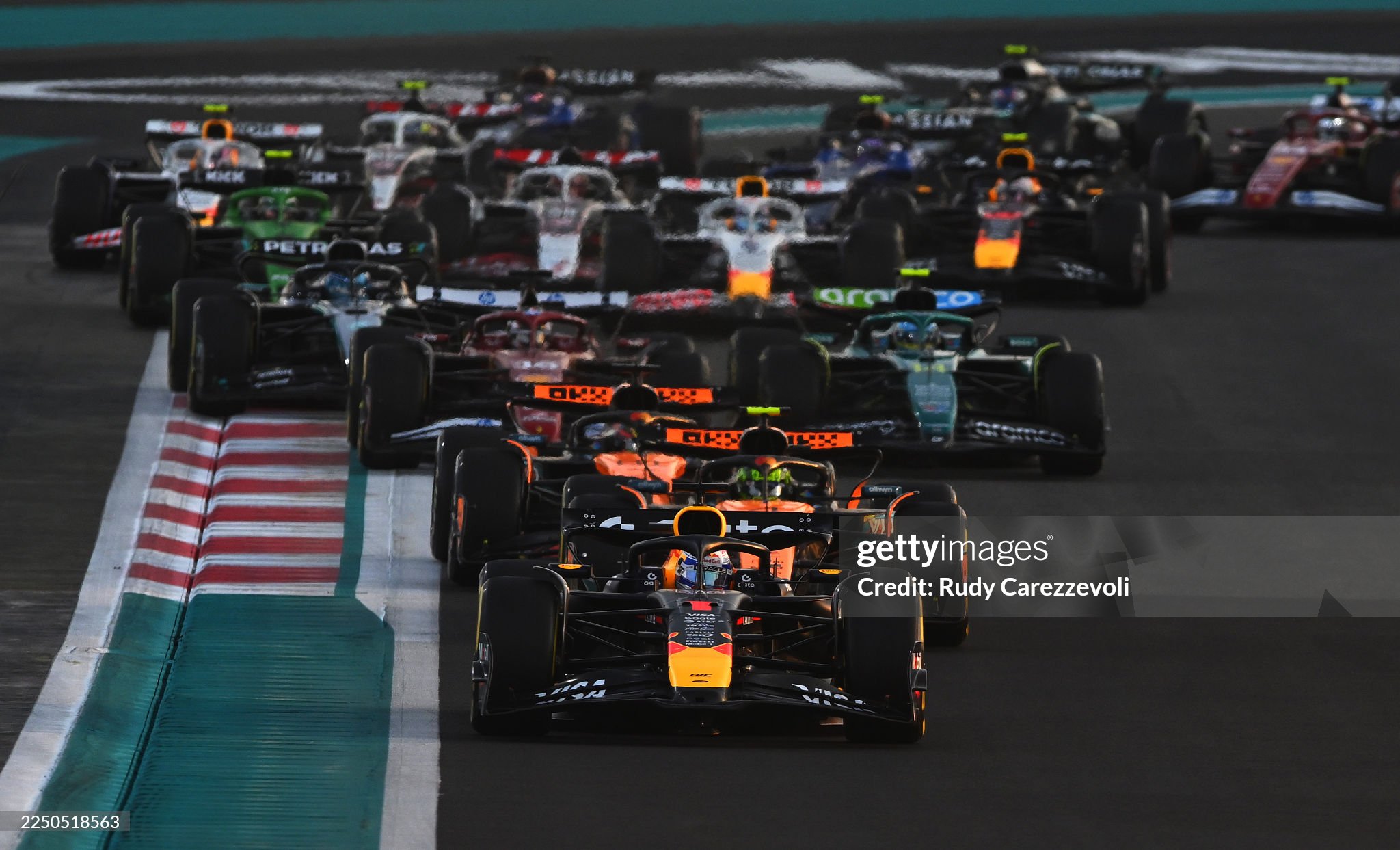 Max Verstappen, driving the Red Bull Racing RB21, leads Lando Norris, driving the McLaren MCL39 Mercedes, Oscar Piastri, driving the McLaren MCL39 Mercedes and the rest of the field at the start of the F1 Grand Prix of Abu Dhabi at Yas Marina circuit on 07 December 2025. 