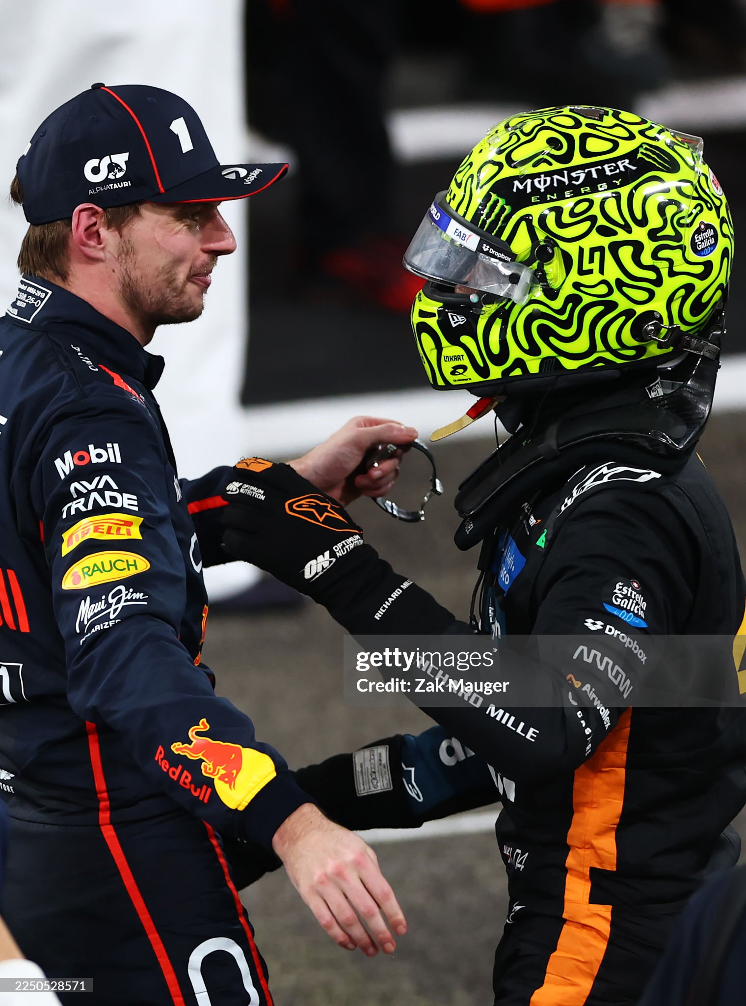 Race winner Max Verstappen of the Netherlands and Red Bull Racing congratulates 2025 F1 World Drivers champion and third placed Lando Norris of Great Britain and McLaren in parc ferme after the F1 Grand Prix of Abu Dhabi at Yas Marina Circuit on 07 December 2025.