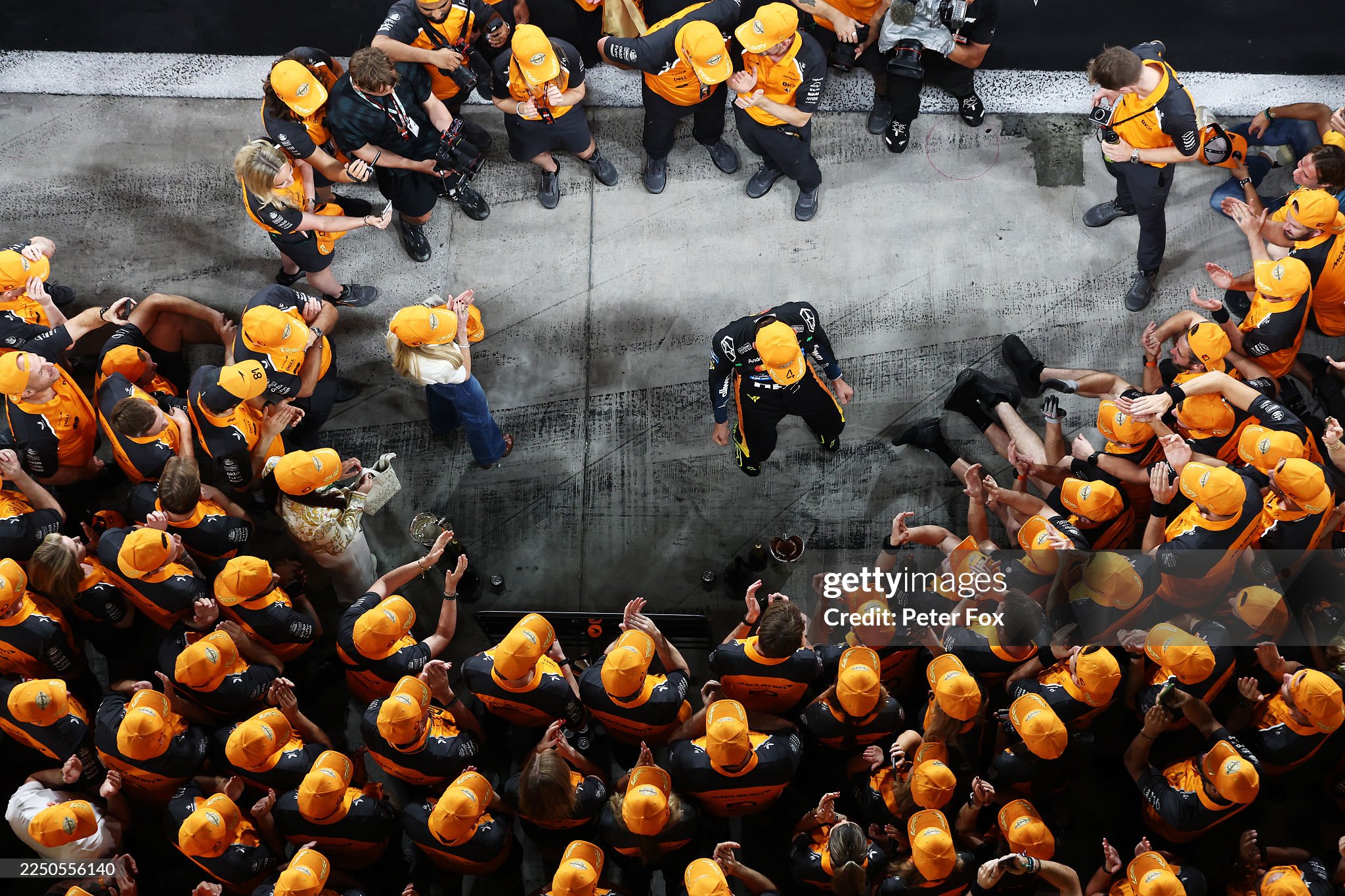 2025 F1 World Drivers champion Lando Norris of Great Britain and McLaren celebrates with his team after the Abu Dhabi Grand Prix at Yas Marina circuit on 07 December 2025. 