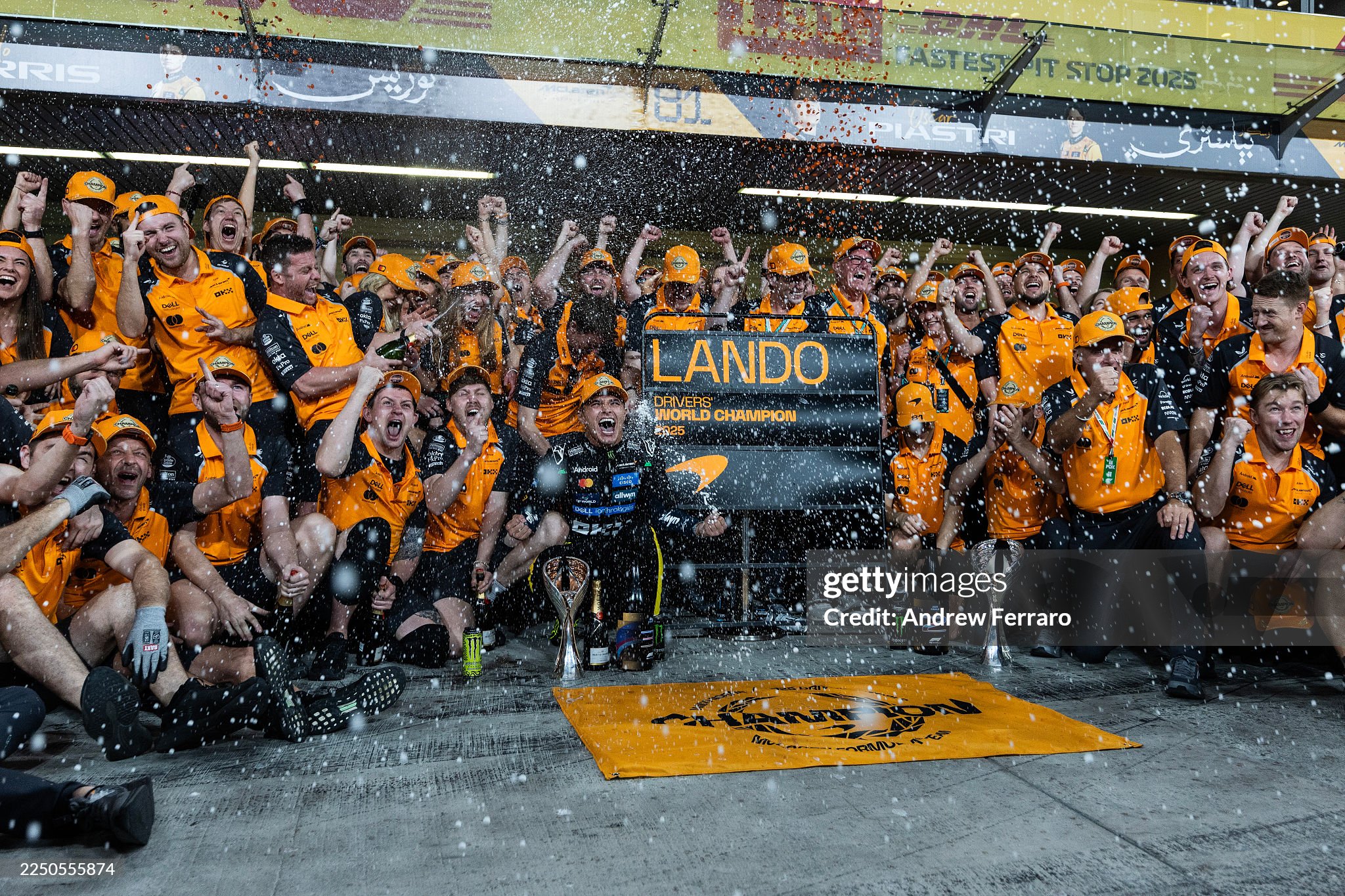 2025 F1 World Drivers champion Lando Norris of Great Britain and McLaren celebrates with his team after the Abu Dhabi Grand Prix at Yas Marina circuit on 07 December 2025.