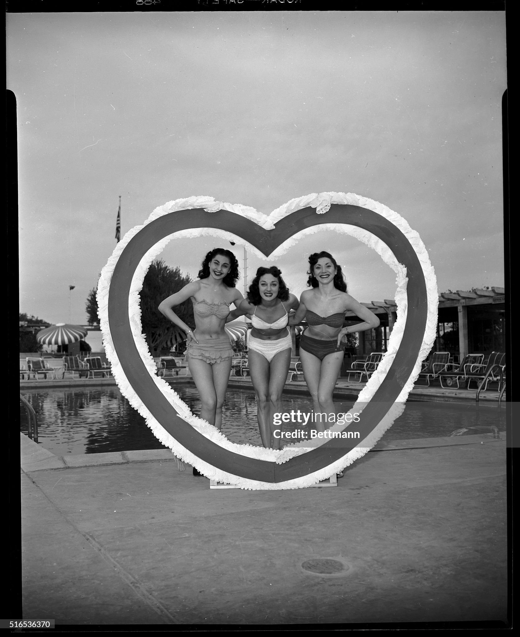 Ready to purvey the spirit of St. Valentine's Day, these three, from the Hotel Last Frontier, rehearse a special heart show outdoors for visitors who will spend Valentine's Day in Las Vegas. From left to right: Renee Molnar, Candyce King and Dolores Frazzini. Undated photo circa 1940s. 