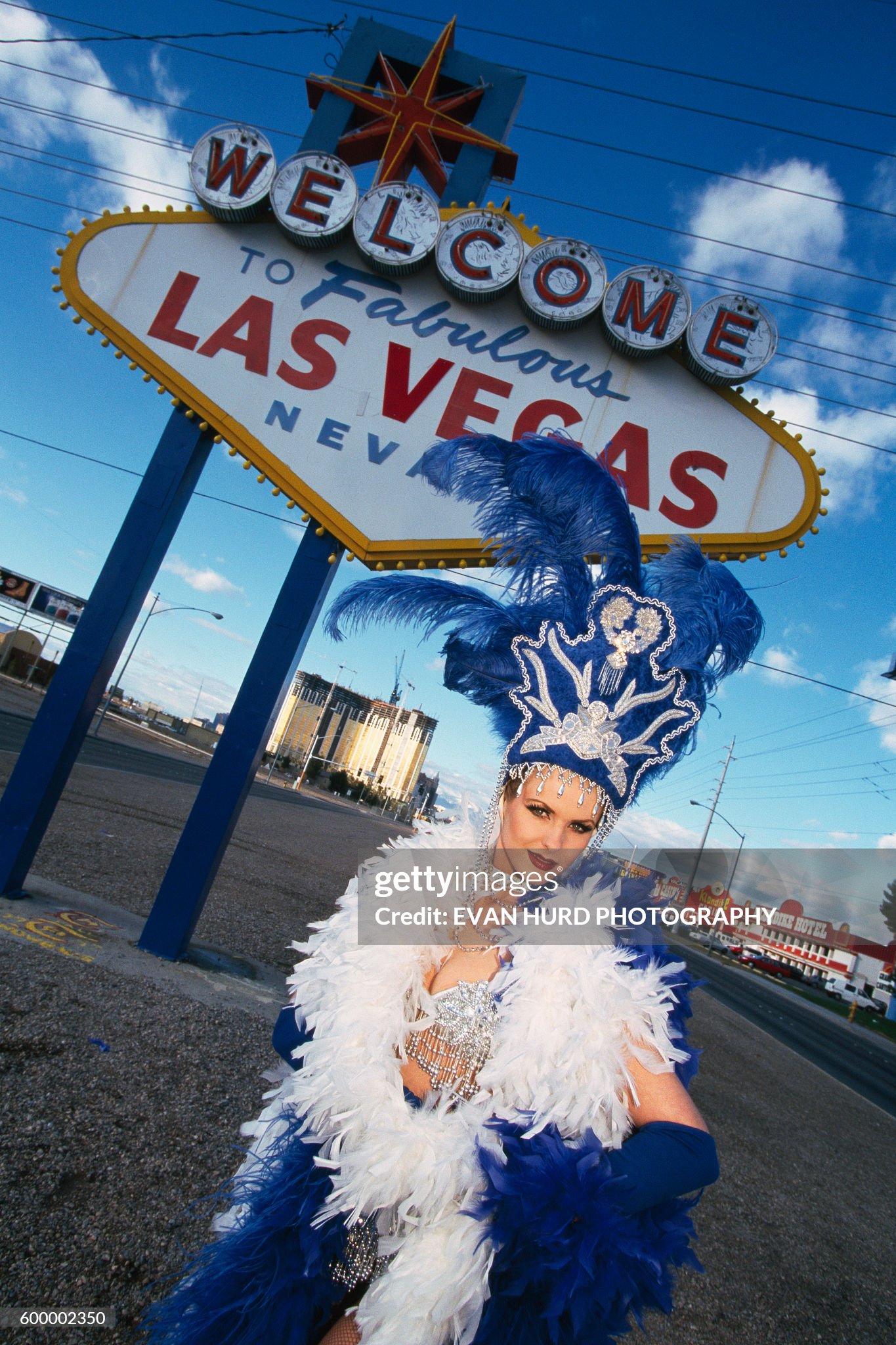 A British show girl in front of a welcome to Las Vegas sign in 1998. 