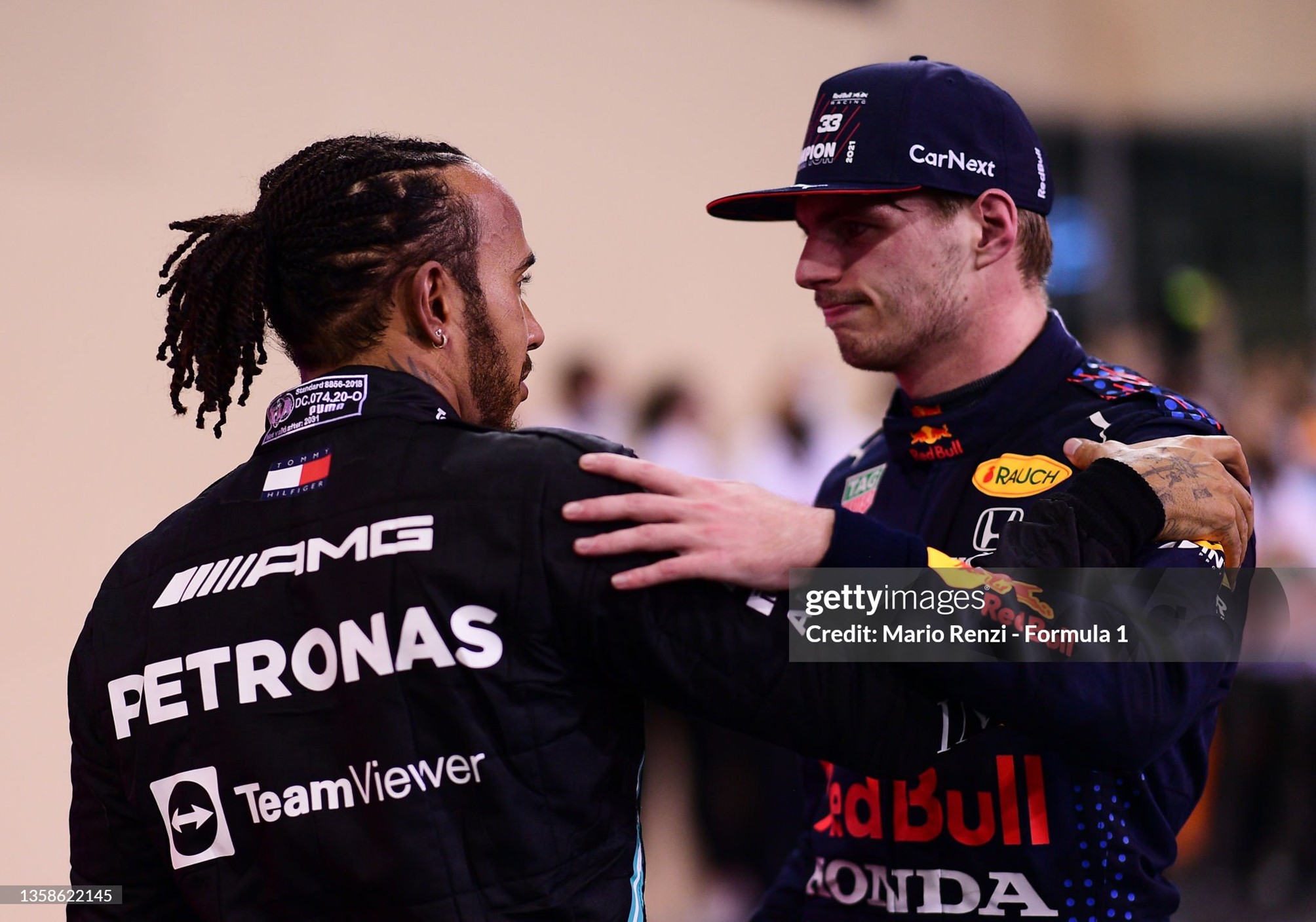 Race winner and 2021 F1 World Drivers Champion Max Verstappen of Netherlands and Red Bull is congratulated by runner up in the race and championship Lewis Hamilton of Great Britain and Mercedes after the F1 Grand Prix of Abu Dhabi at Yas Marina Circuit on 12 December 2021 in Abu Dhabi, United Arab Emirates. 