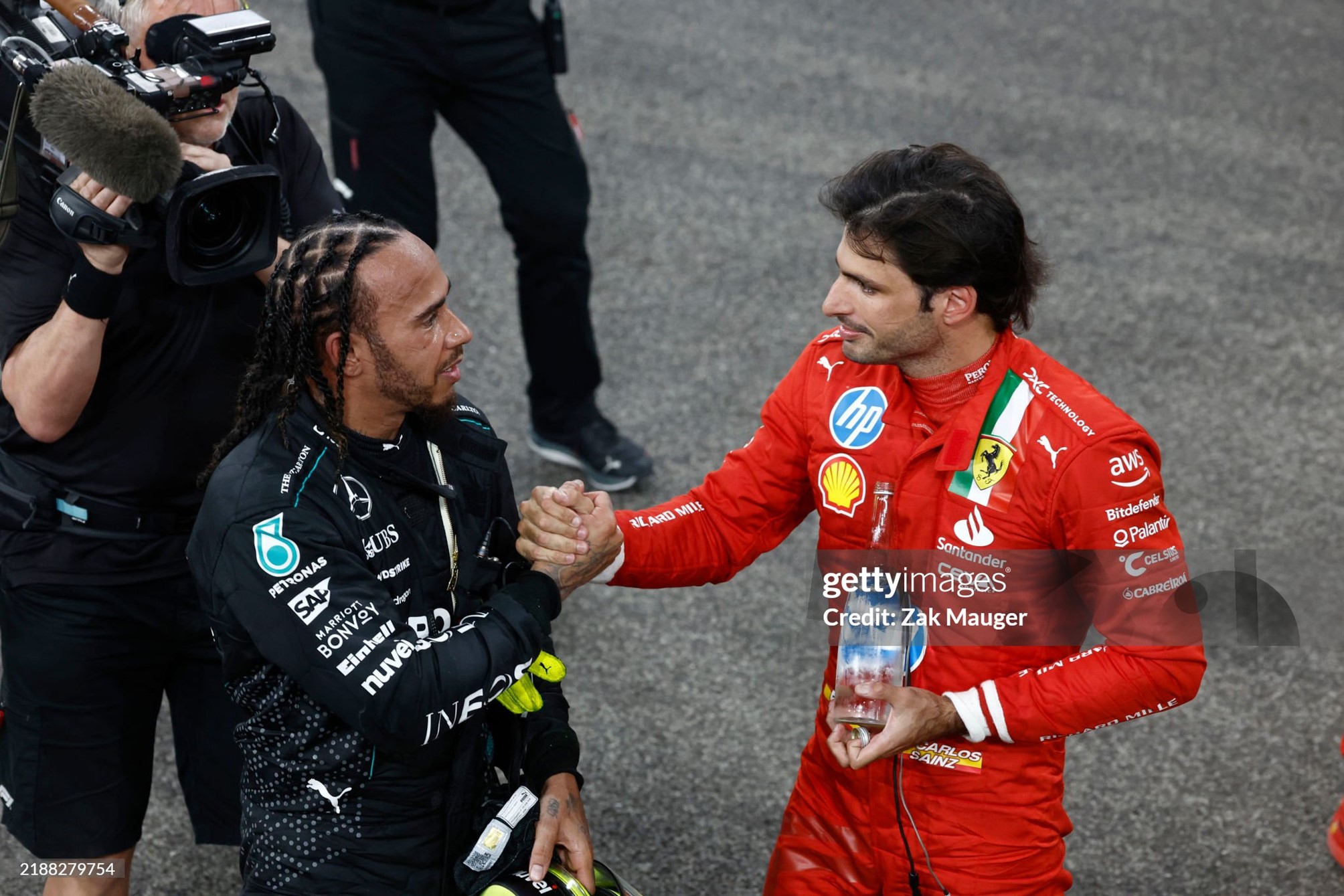 Lewis Hamilton, Mercedes-AMG, congratulates Carlos Sainz, Ferrari, after the Grand Prix of Abu Dhabi at Yas Marina Circuit on December 08, 2024. 