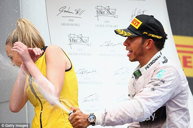 Lewis Hamilton celebrates his victory by soaking a grid girl with champagne at the Spanish Grand Prix on 11 may 2014.