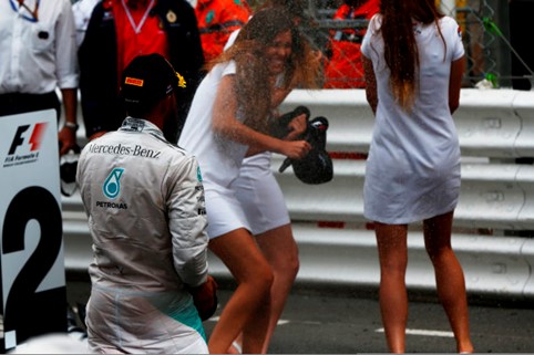 Lewis Hamilton, Mercedes AMG, 2nd position, hoses down some grid girls with champagne at Monte Carlo on Sunday 25 May 2014. 