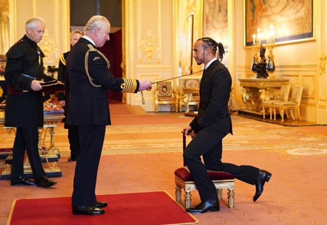 Lewis Hamilton is knighted by Prince Charles for his contribution to motorsport at Windsor Castle in December 2021.